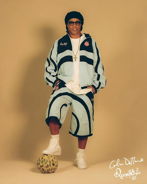 Ronaldinho fashion outfit with foot on the ball